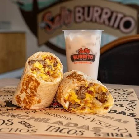 Two cut burritos beside a Salty Burrito drink