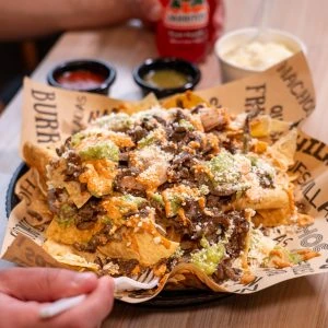Loaded carne asada fries covered with cheese and sauce