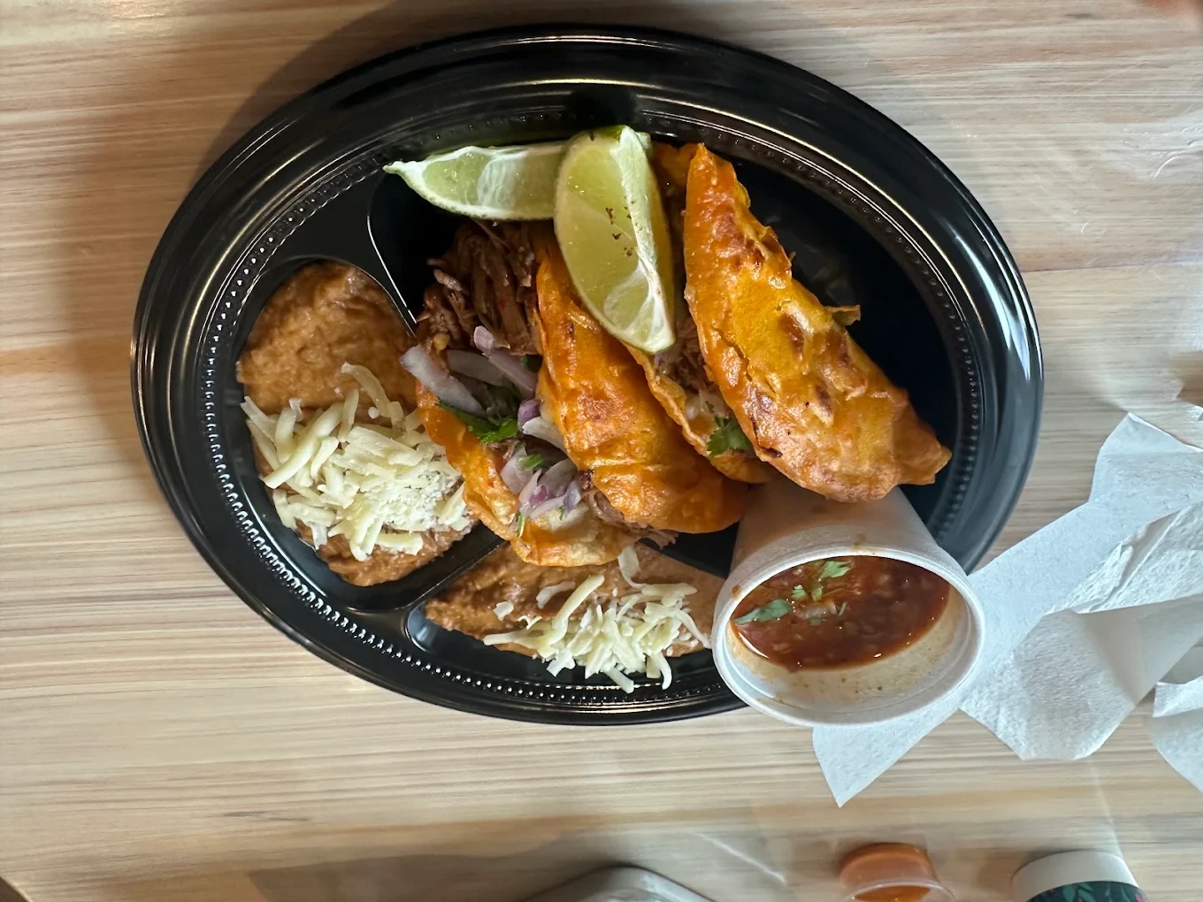 Crispy tacos served with rice, lime and salsa