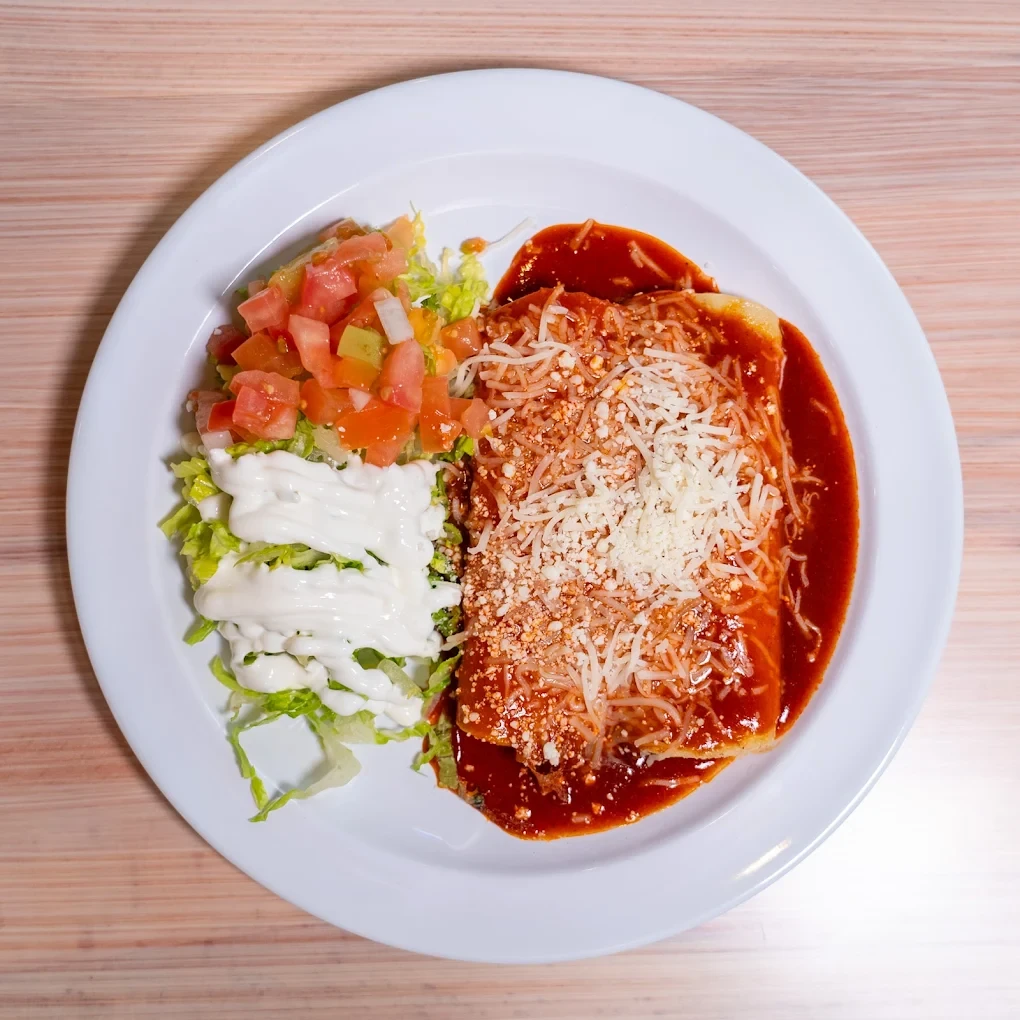 Enchiladas served with rice, pico de gallo and crema