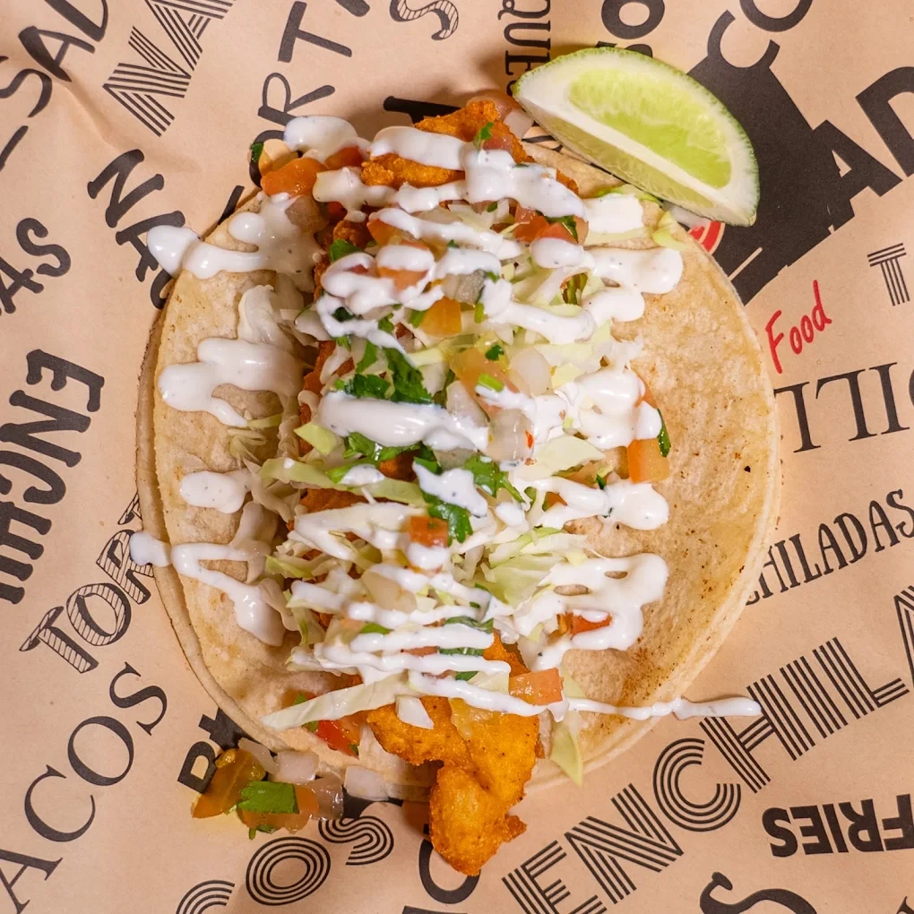 Loaded fries with cotija, crema and fresh lime