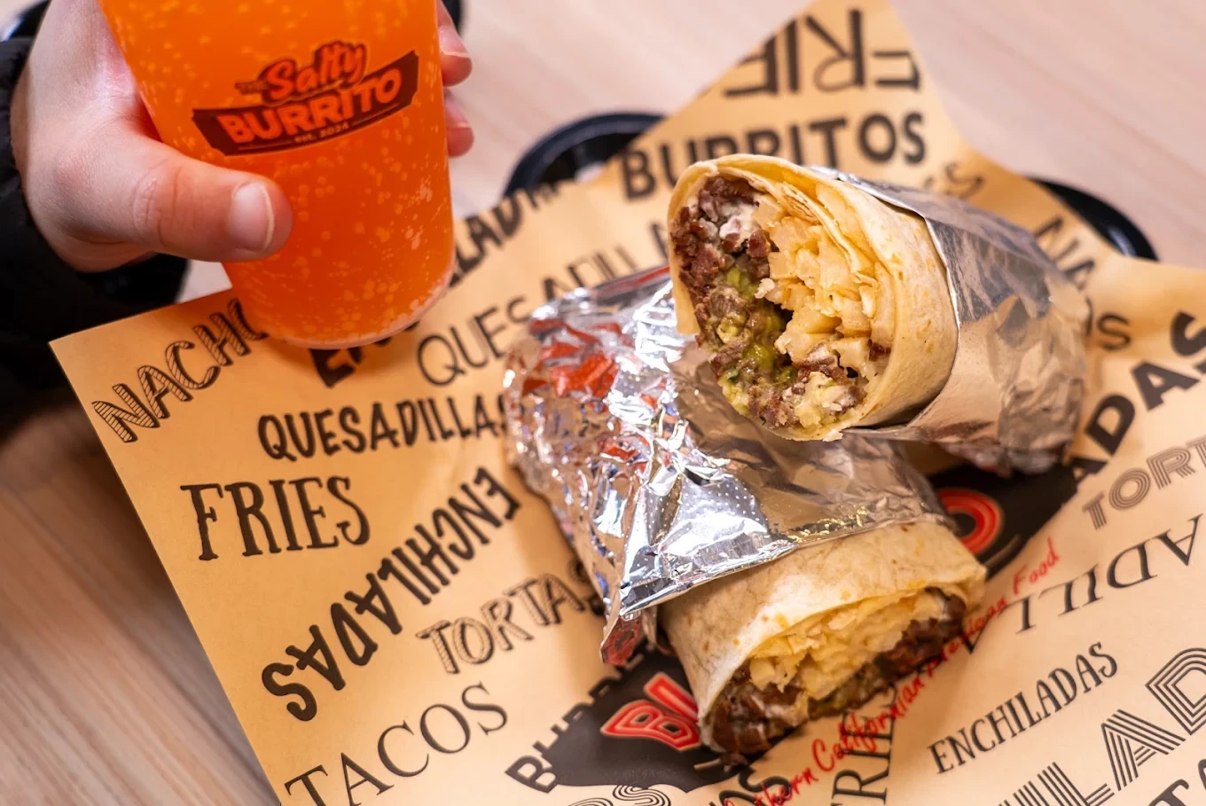 A Salty Burrito meal and house drink ready at the counter